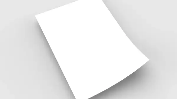 Une feuille blanche, en format demi raisin, est posée sur un fond gris clair, créant une ombre douce.